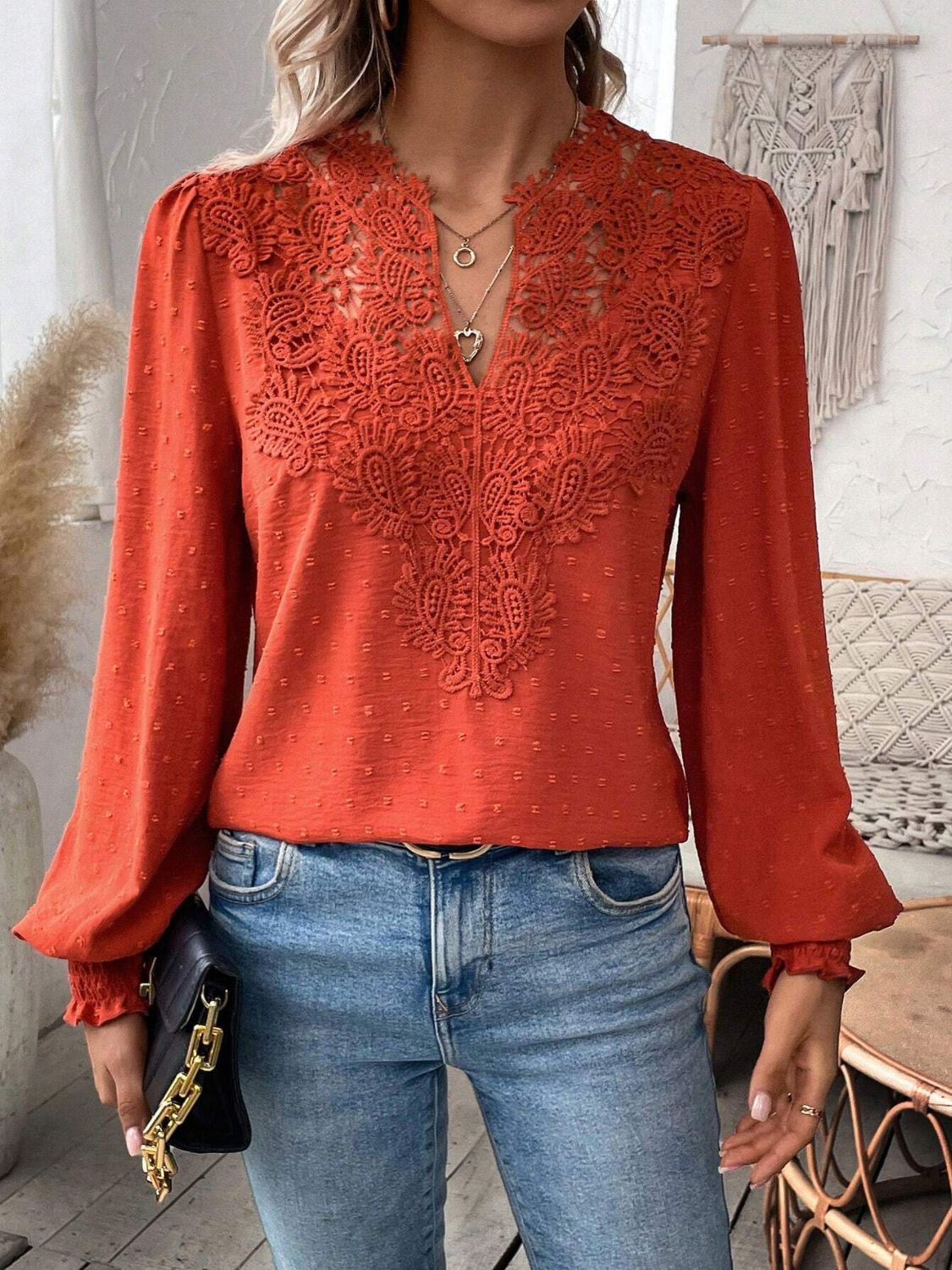 Orange-red blouse with lace yoke detail and puff sleeves