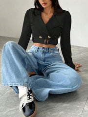 Black cropped double-breasted trench coat with belt and gold buttons.