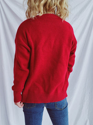 Scarlet knit jumper with crew neck, long sleeves, and ribbed cuffs and hem.