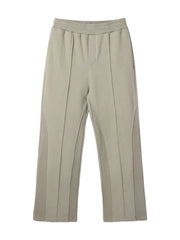 Beige lounge trousers with vertical seam details and a wide leg.
