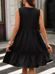 Black sleeveless V-neck dress with ruffle hem and textured fabric