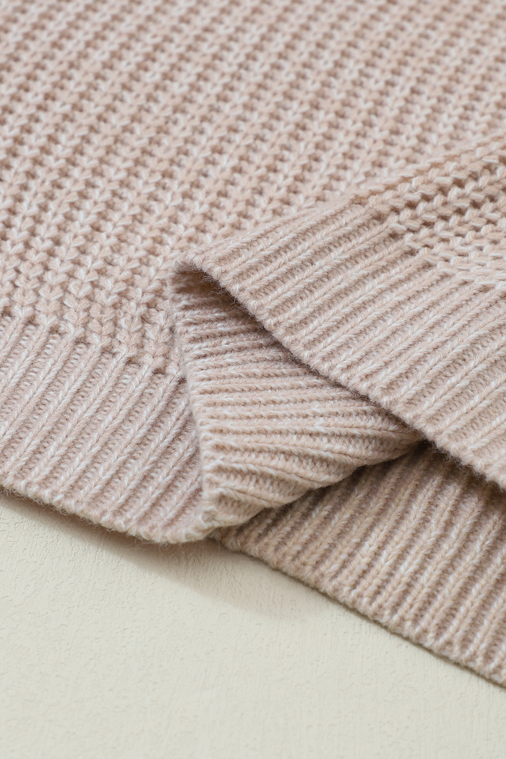 Textured knit sweater in tan acrylic with ribbed details and diamond pattern.