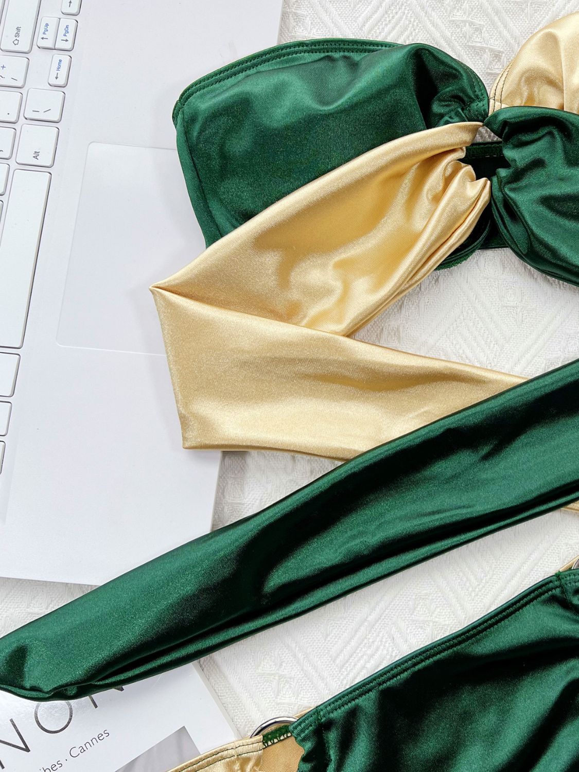 Two-tone bandeau bikini in forest green and gold with ring detail and tie straps.