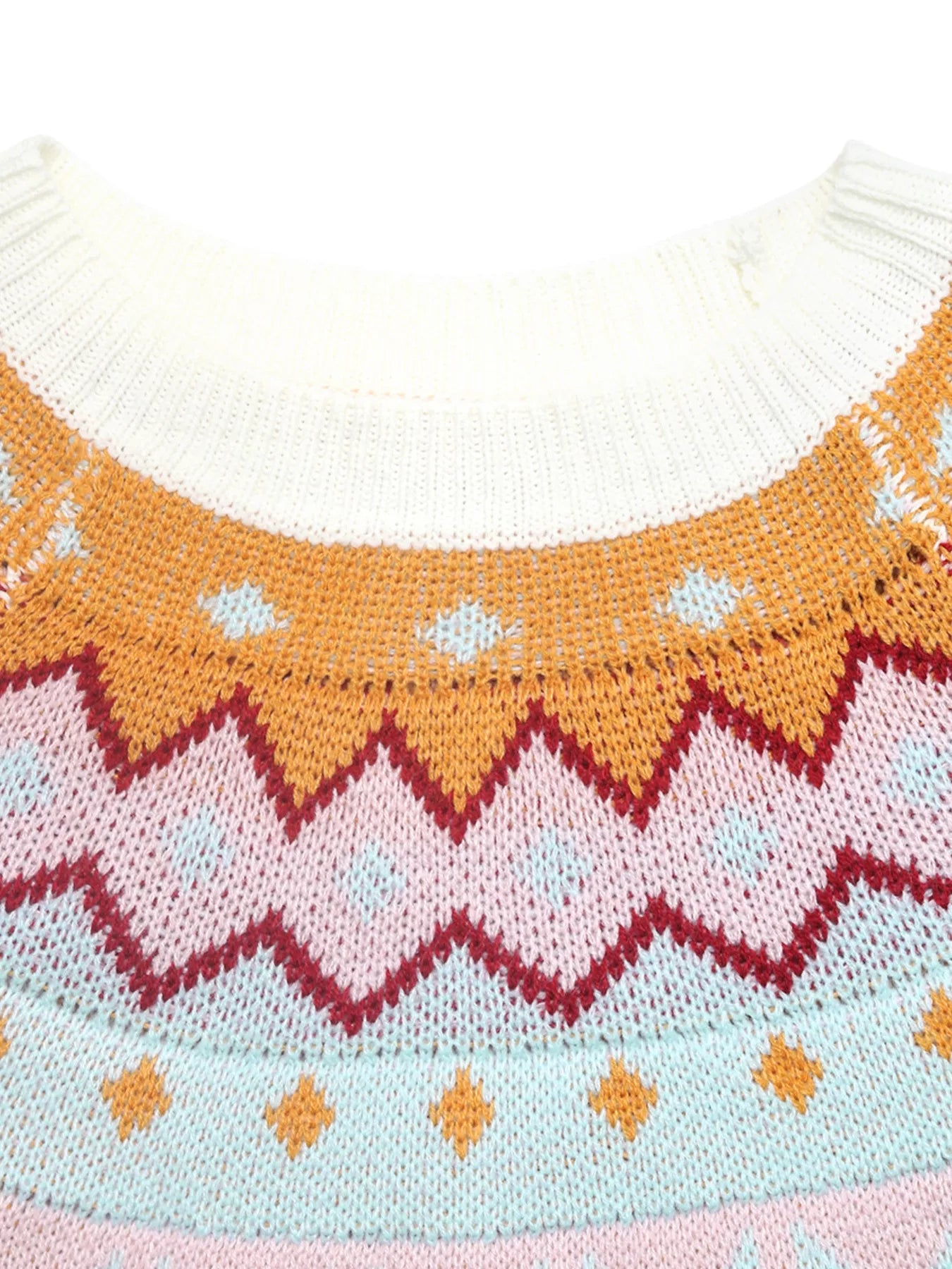 Geometric knit sweater in white with colorful chevron and diamond patterns.