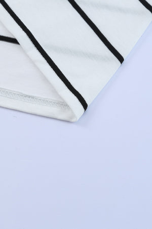 White maxi dress with black horizontal stripes and a slit hem detail.