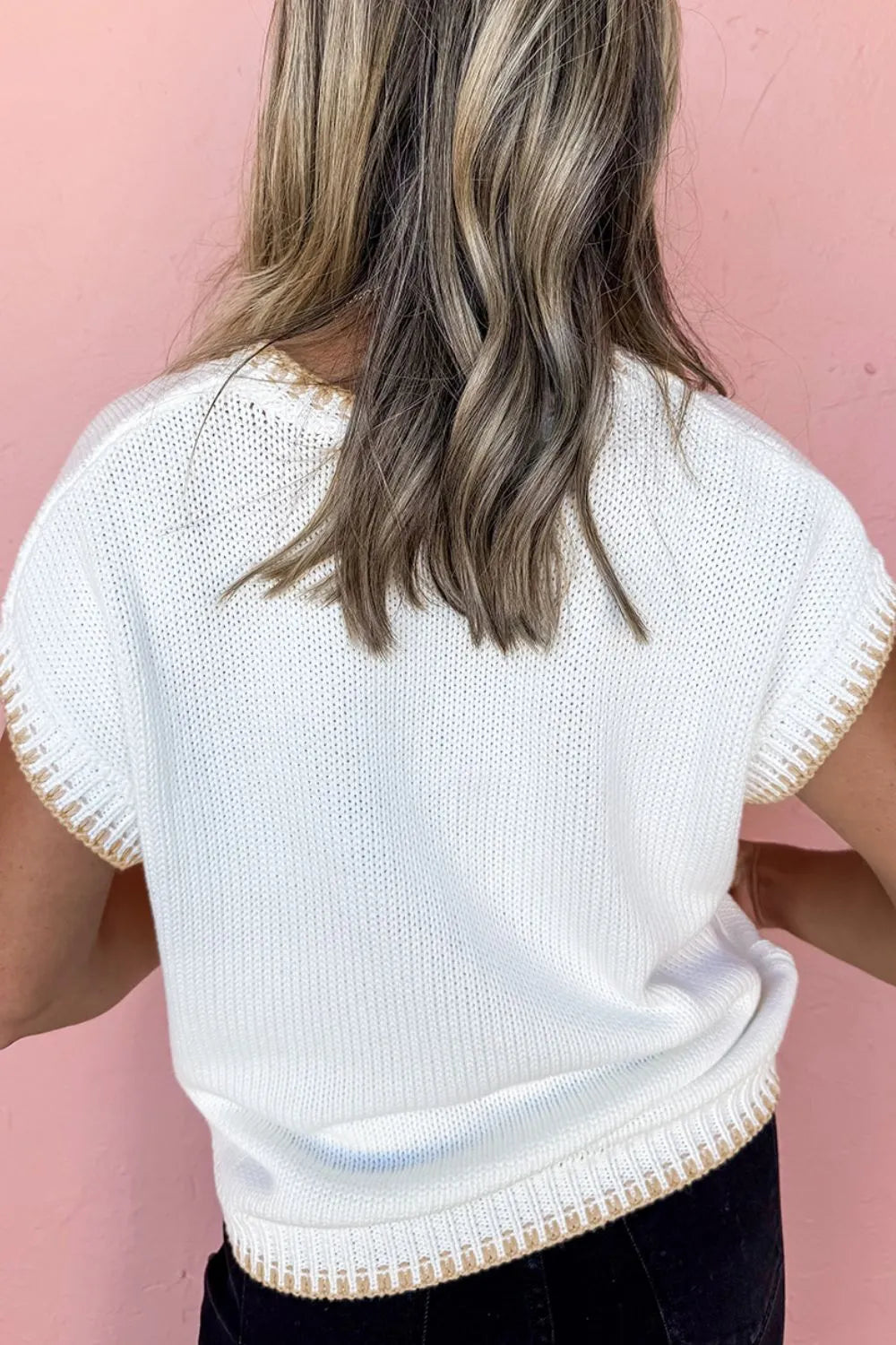 White knit sweater top with stitch trim detail on sleeves and hem