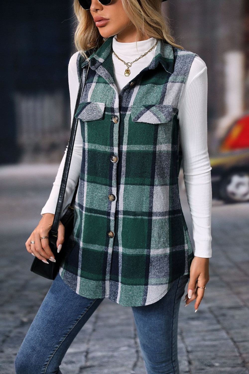 Plaid utility vest in dark green with button front and patch pockets.