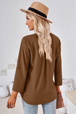 Brown textured henley blouse with rolled sleeves and a relaxed fit.