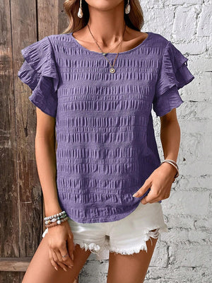 Purple smocked blouse with ruffle sleeves and textured fabric.