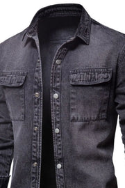 Faded dark denim utility shirt jacket with buttoned chest pockets and collar.