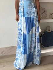 Scalloped neckline maxi dress in blue abstract patchwork print with white trim.