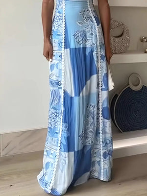 Scalloped neckline maxi dress in blue abstract patchwork print with white trim.