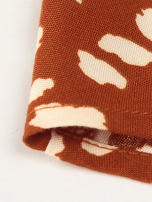 Orange animal print midi dress fabric detail with tied waist detail