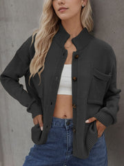 Gray acrylic knit cardigan with stand collar, buttons, and chest and side pockets.