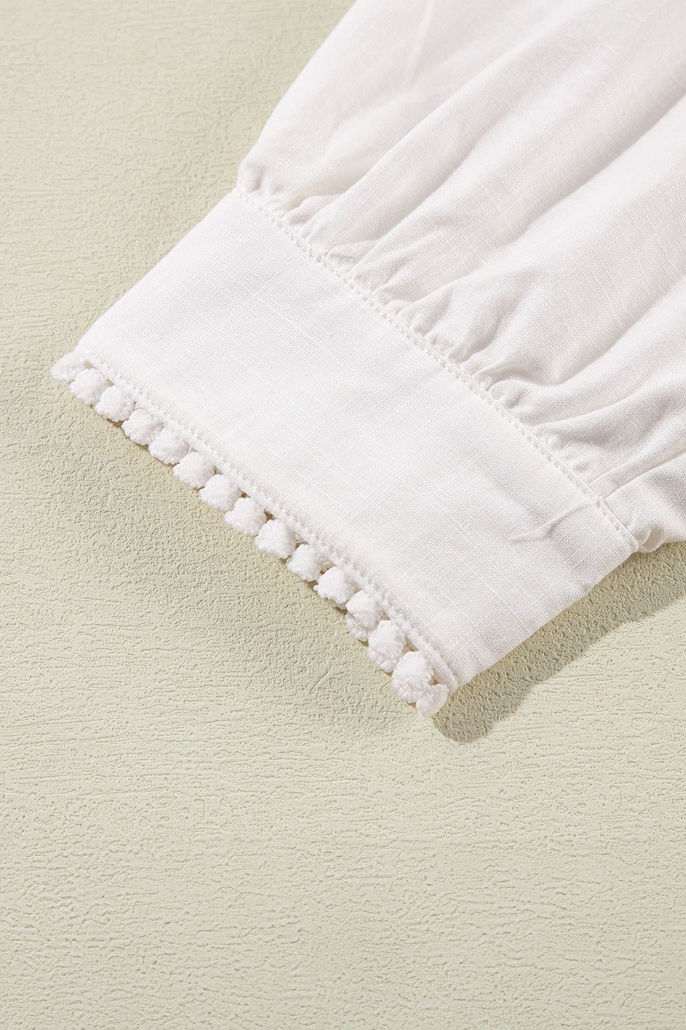 White linen blouse with scalloped trim and gathered sleeves