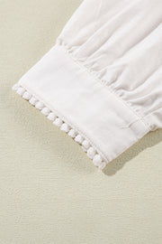 White linen blouse with scalloped trim and gathered sleeves