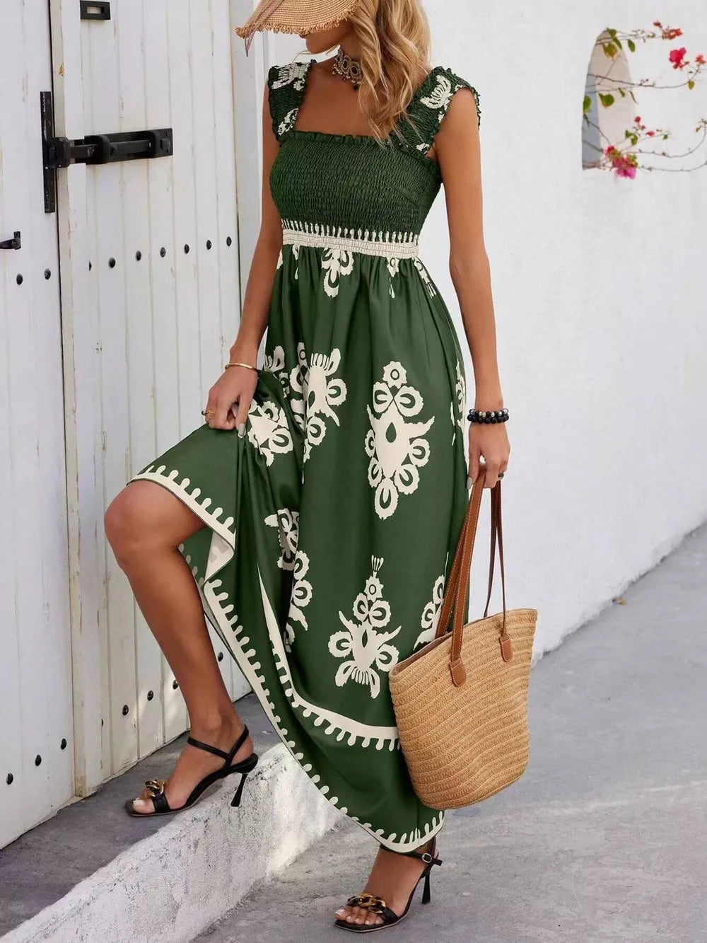 Dark green smocked square neck maxi dress with white floral print and ruffled cap sleeves.
