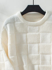 Cream checkerboard knit pullover sweater with textured squares and crew neck.
