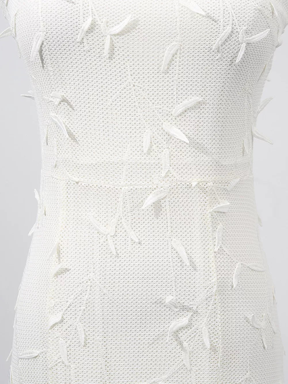 White midi dress with floral applique detail and textured knit fabric.