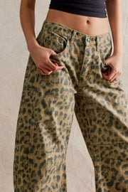 Leopard print denim barrel leg pants with button fly and pockets.