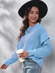 Pastel blue ribbed knit pullover sweater with ruffled sleeves and a crew neck.