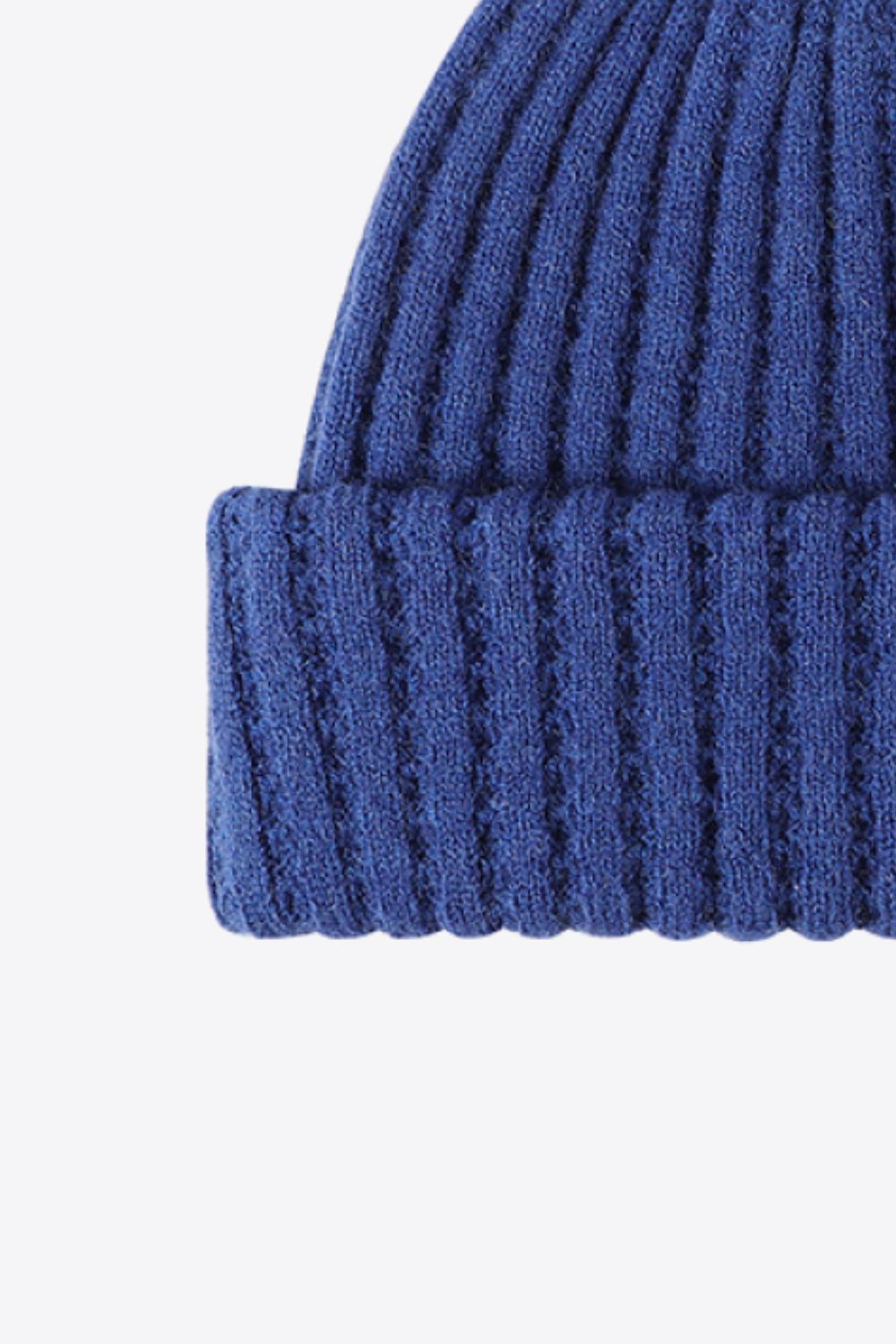 Textured ribbed knit beanie in Indigo acrylic with a cuffed hem.