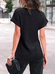 Black ribbed knit t-shirt with cuffed short sleeves and a relaxed fit.