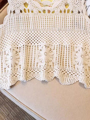 Cream crochet tank top with intricate floral overlay and scalloped hem.