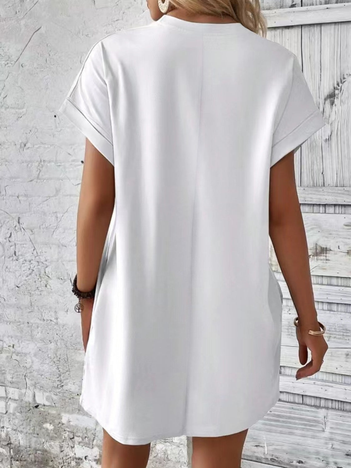 White relaxed tee dress with cuffed sleeves and pockets, casual style