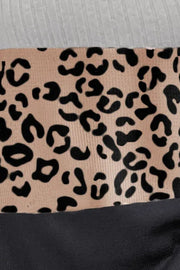 Colorblock leopard print ribbed knit top in tan with black accents and a white ribbed texture.