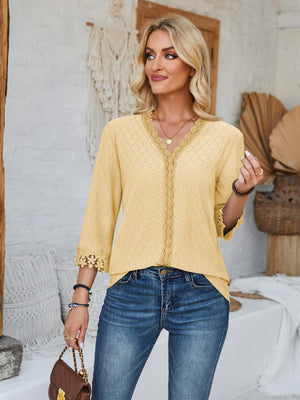 Light Yellow eyelet trimmed V-neck blouse with lace detail and 3/4 sleeves.