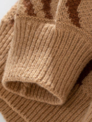 Camel wavy knit crewneck sweater detail showing ribbed cuff and acrylic fabric.