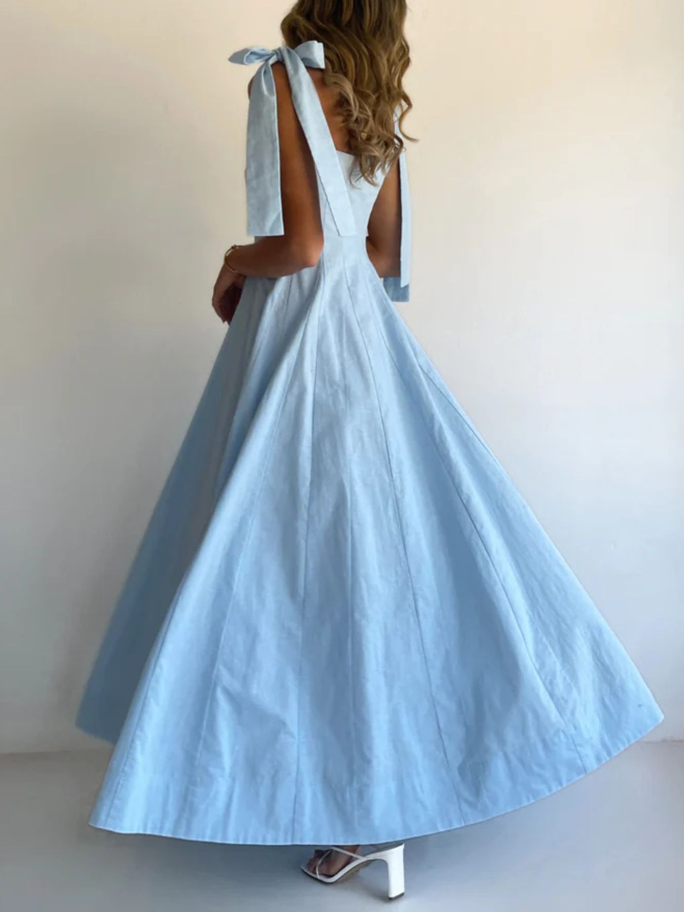 Light blue maxi dress with bow tie shoulder straps and a full skirt.