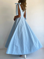 Light blue maxi dress with bow tie shoulder straps and a full skirt.