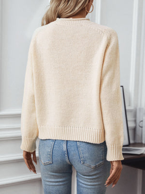 Tan acrylic knit sweater with crew neck and ribbed cuffs and hem.