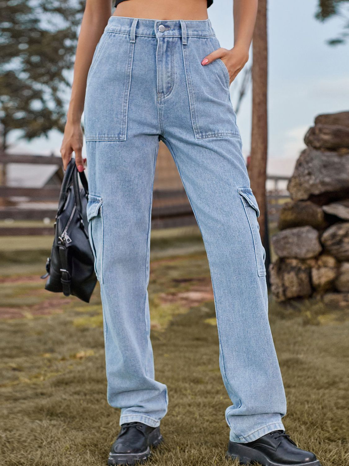 Light wash denim straight leg cargo pants with multiple pockets.