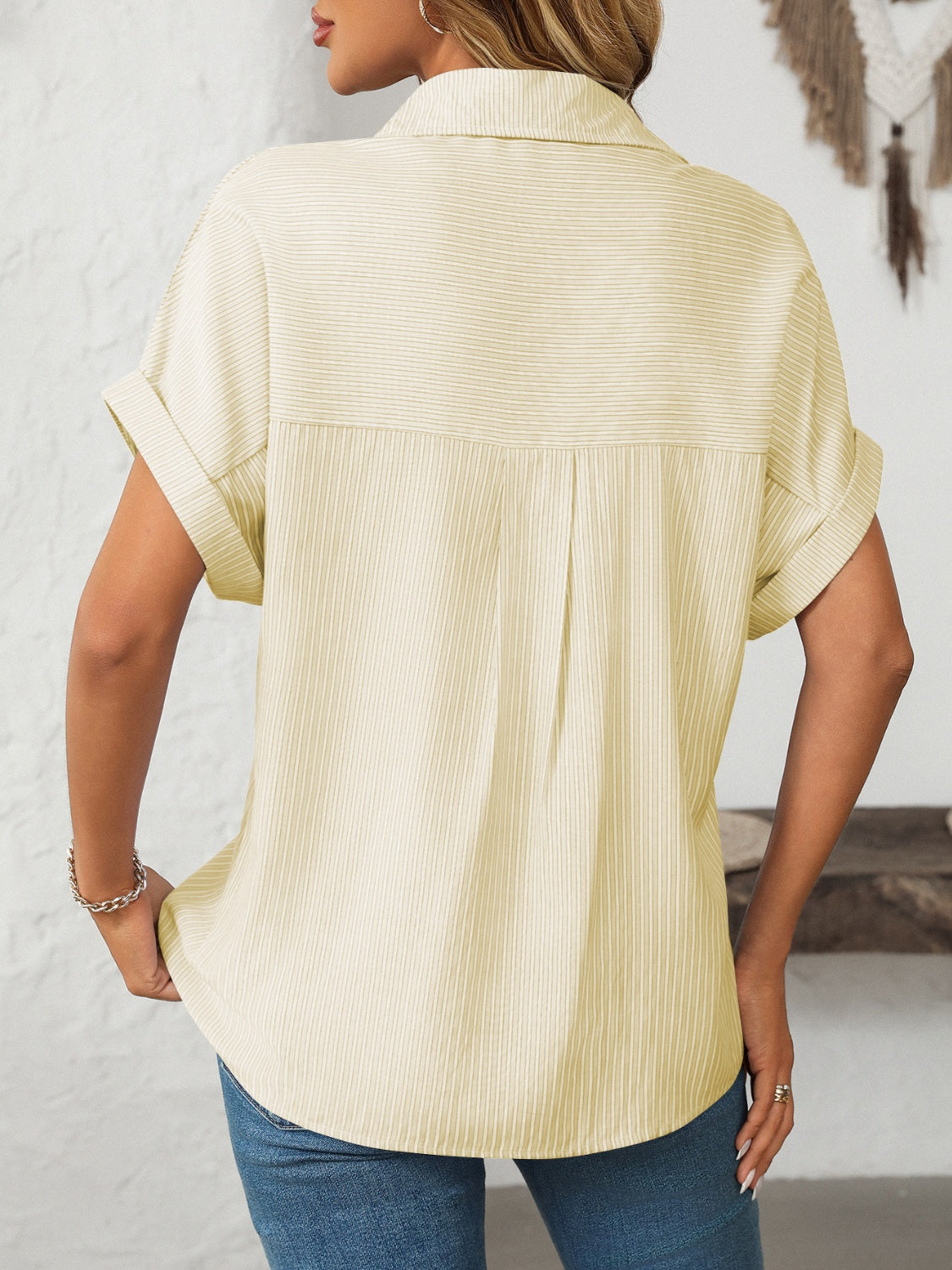 Pastel yellow striped button-down shirt with cuffed short sleeves and a relaxed fit.