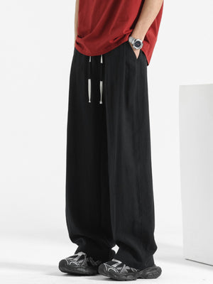 Men's black relaxed fit sweatpants with drawstring and pockets.