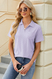 Lavender textured polo shirt with V-neck and short sleeves, featuring a pocket detail.