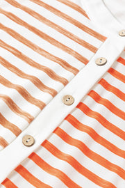 Colorblock stripe sleeveless jumpsuit with wooden buttons and orange and brown stripes.