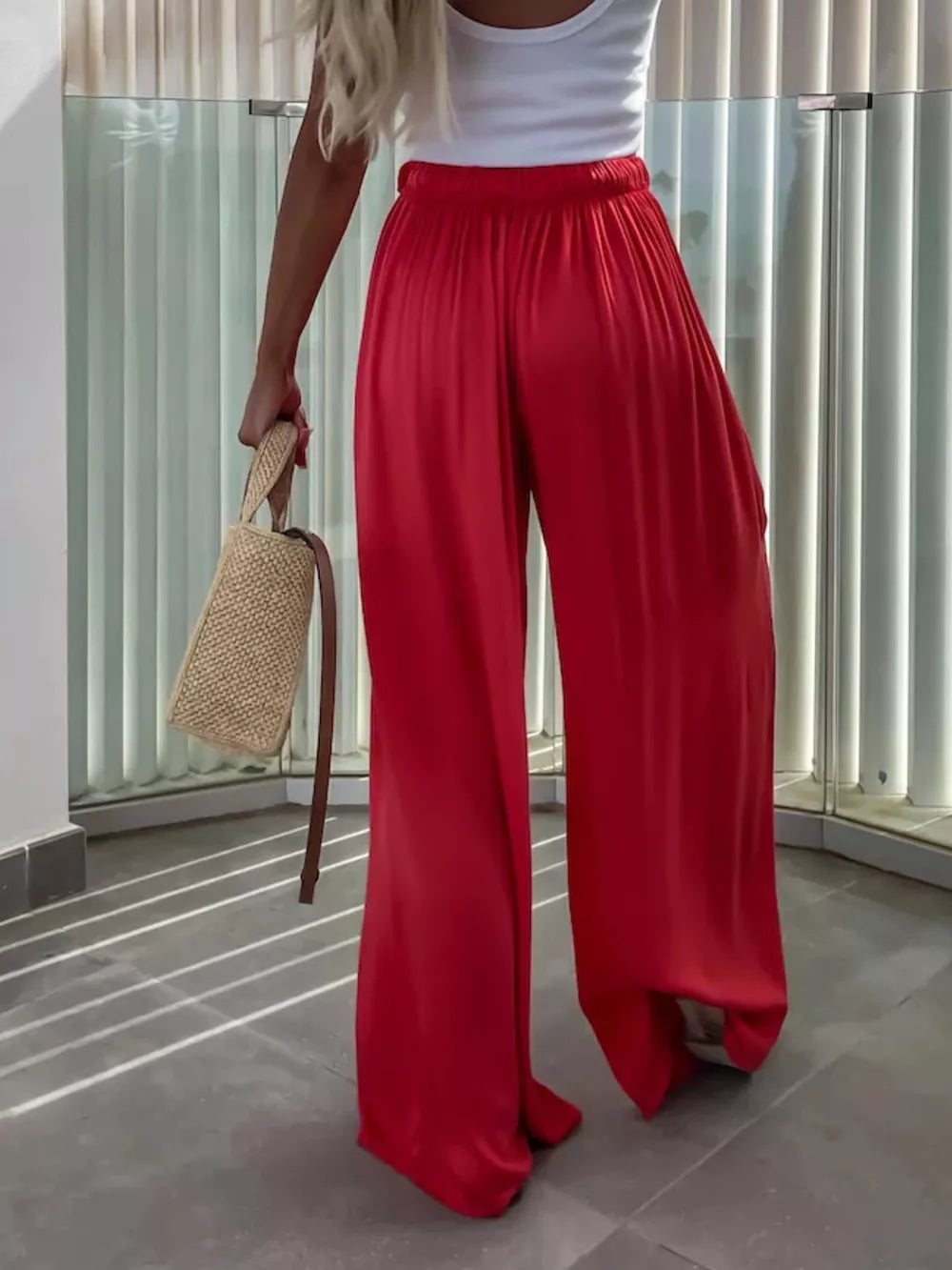 Red maternity pants with paperbag waist and wide legs.
