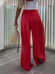 Red maternity pants with paperbag waist and wide legs.