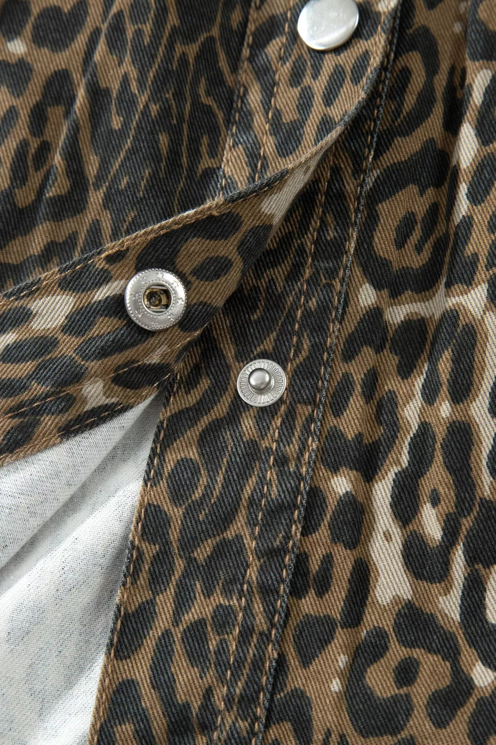 Denim dress with leopard print, snap button closure detail.