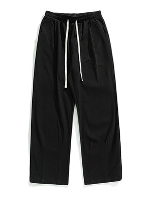 Black wide-leg pleated trousers with drawstring and front pleats