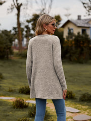 Longline ribbed knit button-down cardigan in beige with long sleeves and a relaxed fit.