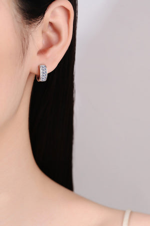 Silver baguette cut crystal huggie hoop earrings with a row of clear crystals.