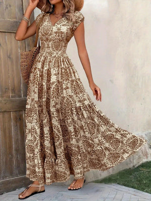 Brown damask print maxi dress with cap sleeves and tiered skirt.