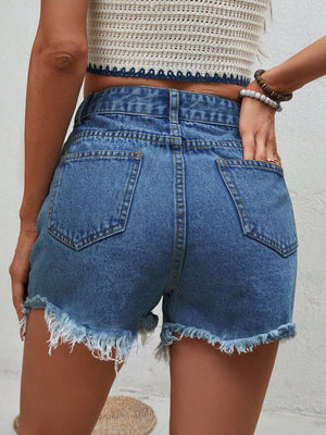 Distressed denim shorts in medium wash with frayed hem and button closure.