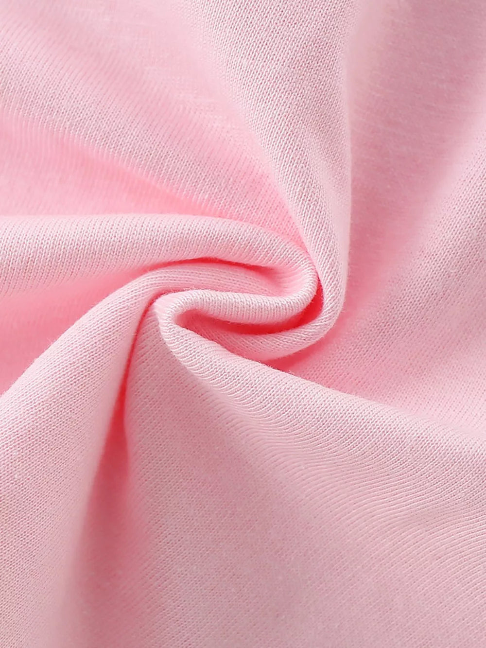 Toddler crew neck t-shirt in blush pink cotton fabric, close-up detail.