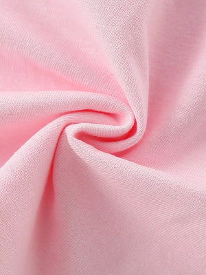 Toddler crew neck t-shirt in blush pink cotton fabric, close-up detail.